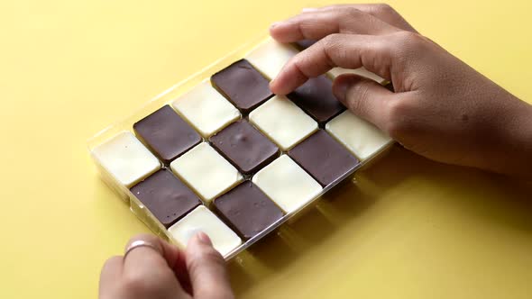 Holding a Box of Dark and White Chocolate