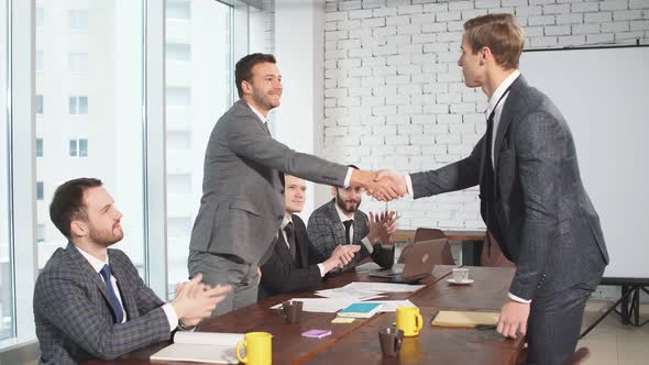 Young Business Partners Shaking Hands