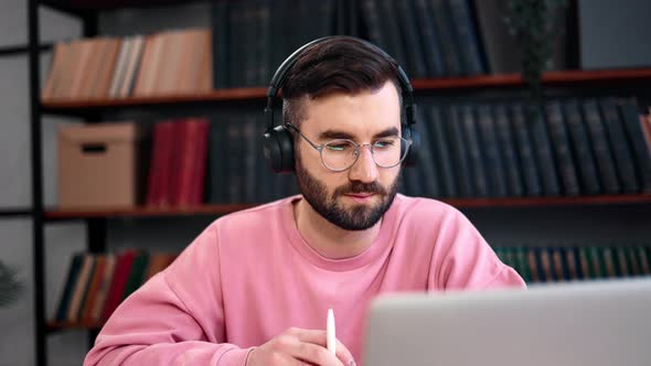 Smart Male Student Listening Internet Webinar Talking Online Video Call Notes Working Library Desk