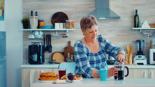 Mature Woman Using French Press