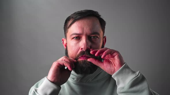 Closeup of Handsome Man Checking Beard and Mustaches