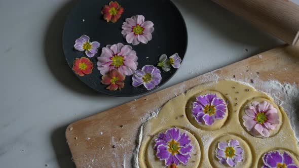 Woman making cookies with Primula petals