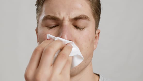 Close Up Portrait of Young Man Wiping His Bleeding Nose with Tissue Slow Motion