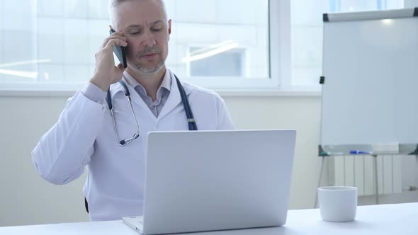 Doctor Talking on Phone with Patient