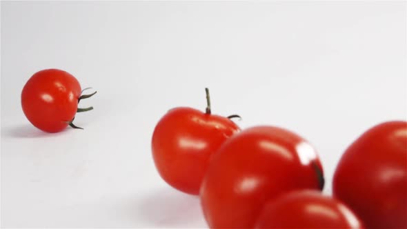 Fresh Tomatoes Fall on White Bg.