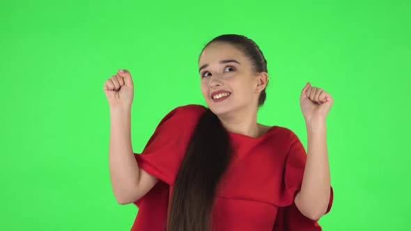 Portrait of Pretty Young Woman Is Dancing Funny. Green Screen