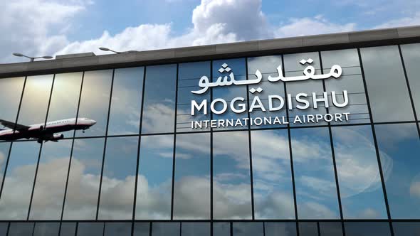 Airplane landing at Mogadishu Somalia airport mirrored in terminal