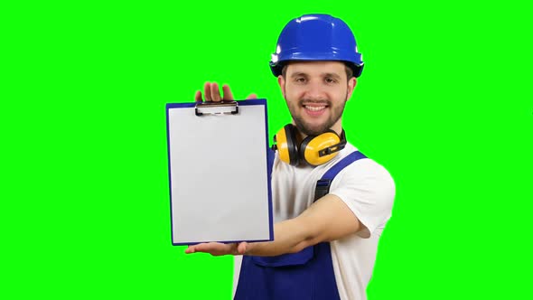 Engineer Picks Up the Paper Plate and Smiles, Green Screen