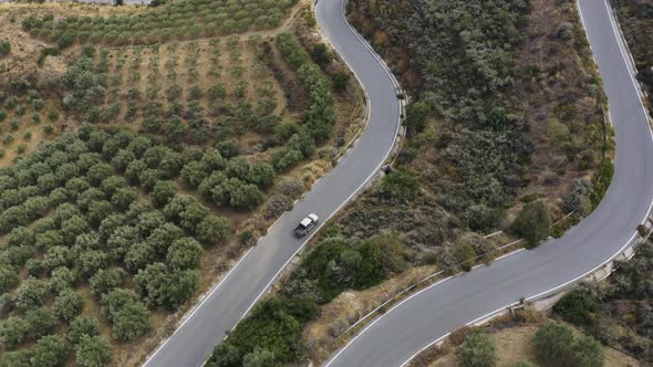 Aerial drone view of pickup machine driving on Countryside road.