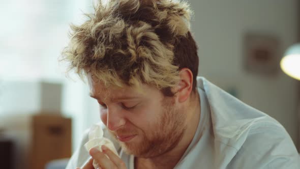 Sick Man Sneezing and Using Nasal Spray