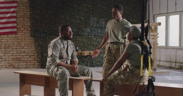 Black Soldier Talking with Squadmates in Gym