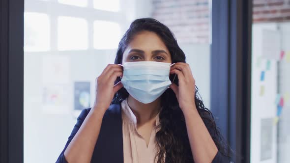 Portrait of woman wearing face mask at office