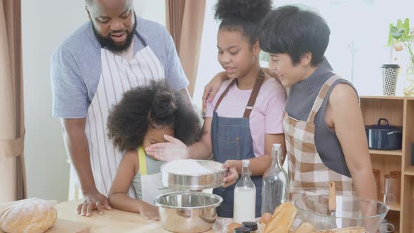 African America family wearing apron for cooking bakery or bread with flour together in the kitchen.