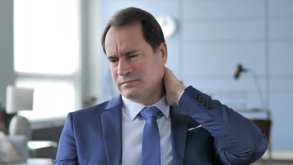 Portrait of Tired Businessman with Neck Pain