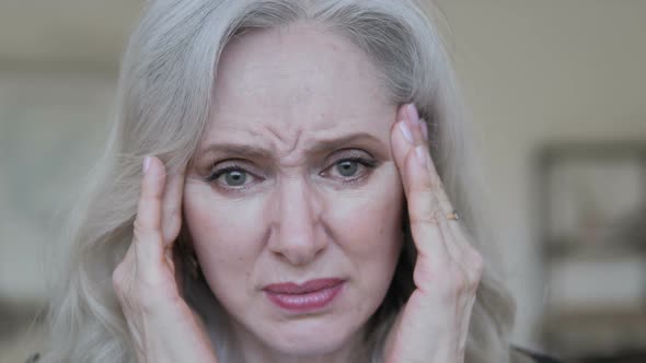 Close Up of Aged Business Woman with Headache