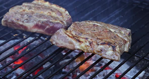 Delicious Juicy Meat Pork Steak Cooking on Grill