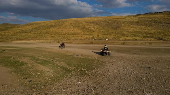 Aerial View From Behind ATVs by Lake and Mountain