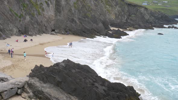 Tourists Enjoying At Coumeenoole Beach, Republic of Ireland - wide shot