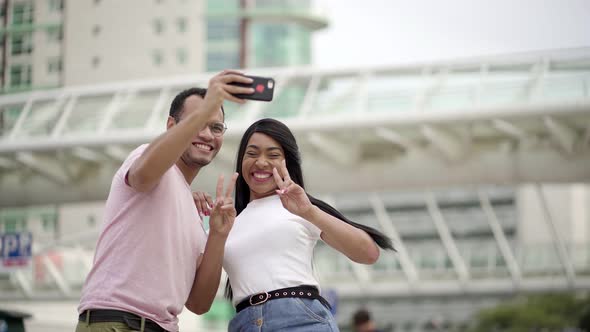 Happy Young Couple Posing for Selfie on Street