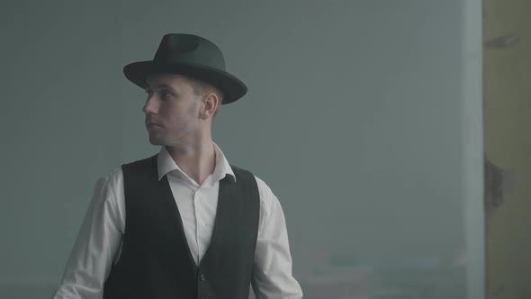 Portrait Confident Man in a Hat Looking To the Camera in an Abandoned Building