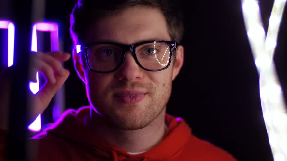 Portrait of Man in Glasses Over Neon Lights 
