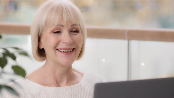 Closeup Happy Mature Businesswoman Typing on Laptop Working Remote Satisfied Elderly Woman