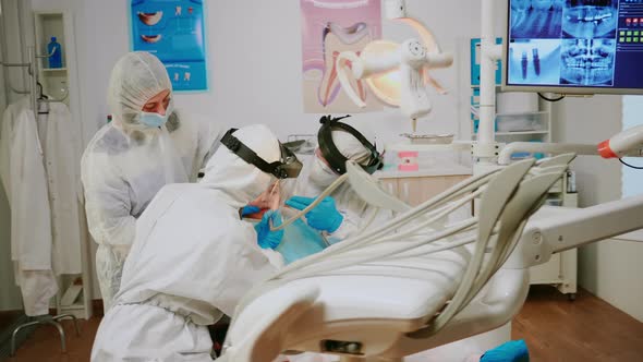 Child on Dental Chair in Dentist Surgery Treated with Dental Drill