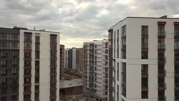 Aerial view of tall residential apartment buildings under construction in a city. Real estate 