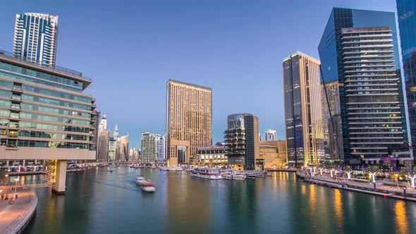 View of Dubai Marina Towers and Canal in Dubai Day to Night Timelapse