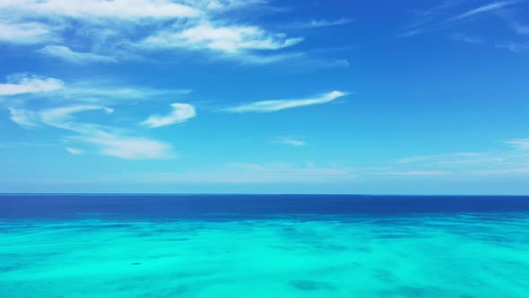 Daytime aerial abstract shot of a white sand paradise beach and aqua turquoise water background in 4