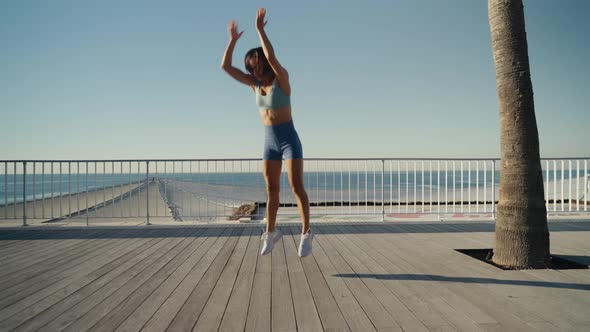 Sportswoman Workout Outdoor on Seaside  She Make Burpee Exercise