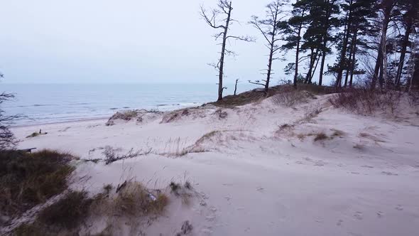 Aerial view of Baltic sea coastline at Bernati beach in Latvia, flying forward through tight coastal