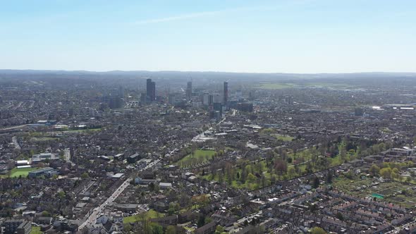 dolly back drone shot over gentrified suburban london looking towards central croydon