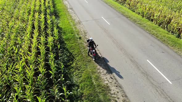 Motorcycle Riding By Country Road on Sunset, Beautiful Adventure Travel Footage Shot From Drone, Top