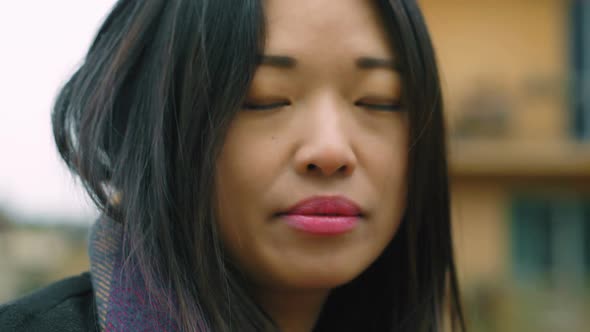 Close up on Beautiful asian woman looking at camera. Portrait of chinese woman