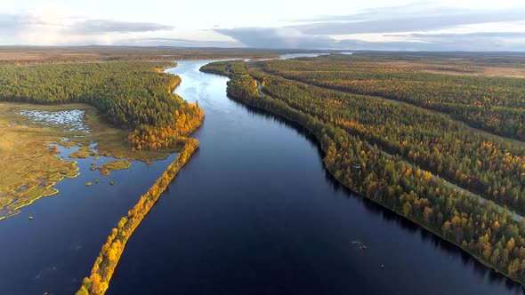 Beautiful Landscape with River and Autumn Trees Forest. Aerial View of Autumn Lapland, Finland