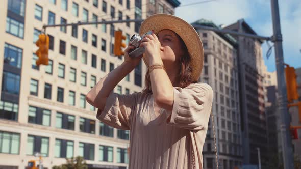 Smiling woman with a camera in Manhattan in New York City