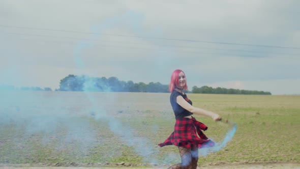 Happy Female Hipster with Smoke Bomb Outdoors