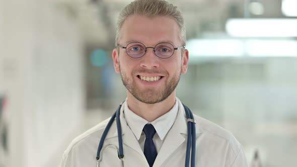 Portrait of Cheerful Male Doctor Smiling at the Camera