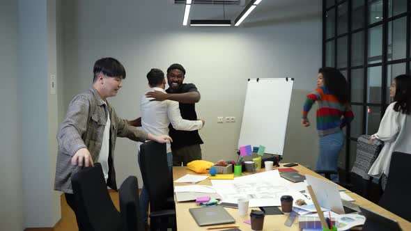 Cheerful Coworkers Greeting Each Other in Office