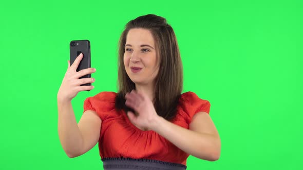 Portrait of Cute Girl Talking for Video Chat Using Mobile Phone and Rejoice. Green Screen