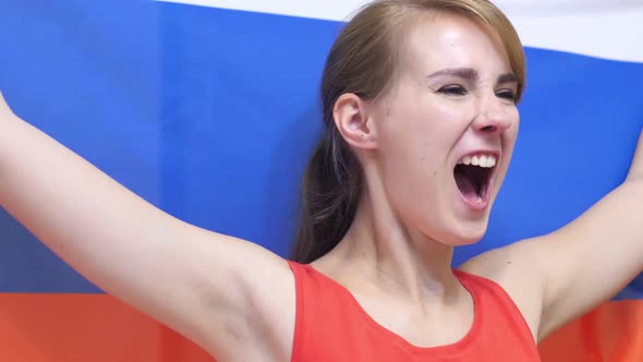 Russian Young Woman Celebrates Holding the Flag of Russia