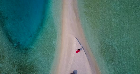 Natural aerial tourism shot of a sunshine white sandy paradise beach and aqua turquoise water backgr