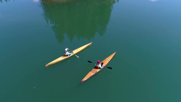 People kayaking in lake 4k