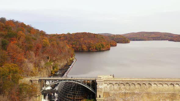 aerial dolly out from the waterfalls at the New Croton Dam in Westchester County, NY. The camera als