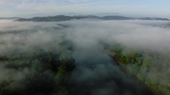 Aerial Drone View of Rainforest River Landscape with Costa Rica Mountains, Beautiful Misty Tropical