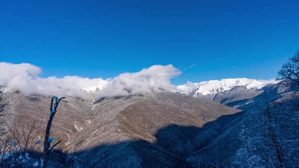 Winter in mountains with snow and clouds time lapse