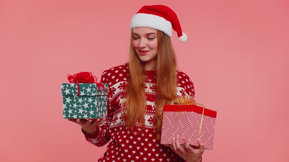 Woman in Christmas Red Sweater Santa Hat Smiling Holding Two Gift Boxes New Year Presents Shopping