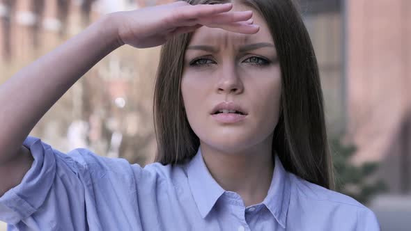 Searching Gesture By Young Woman Outside Office