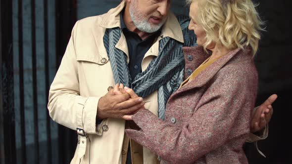 Elderly Couple Hugging Outdoors